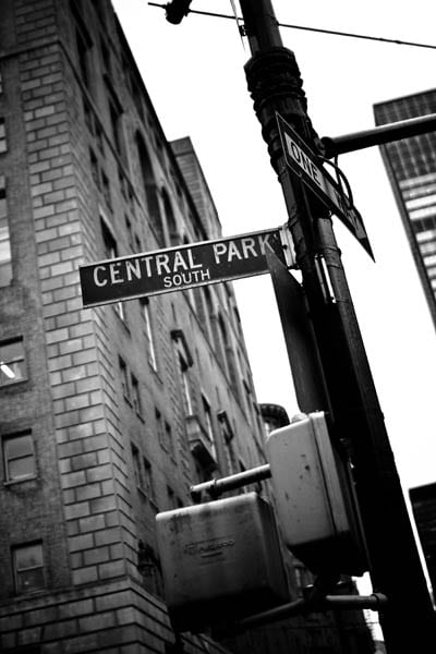 A black and white photo of the central park south sign.