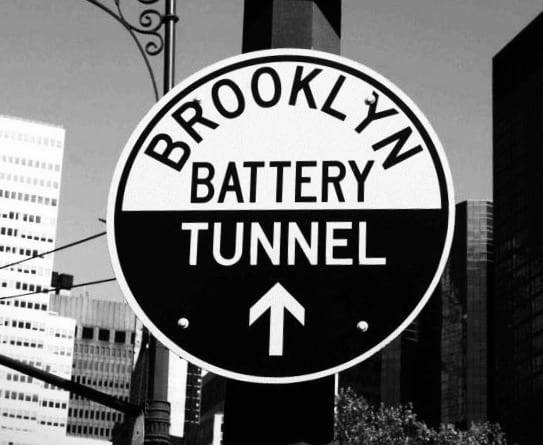 A black and white photo of a street sign.