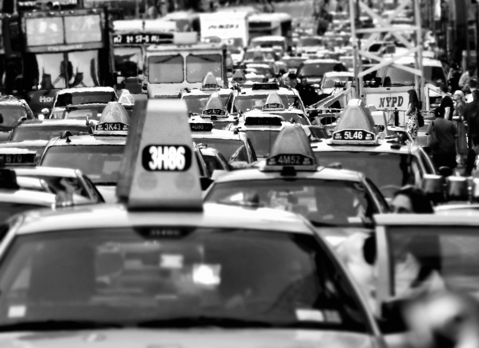 A black and white photo of a busy street.