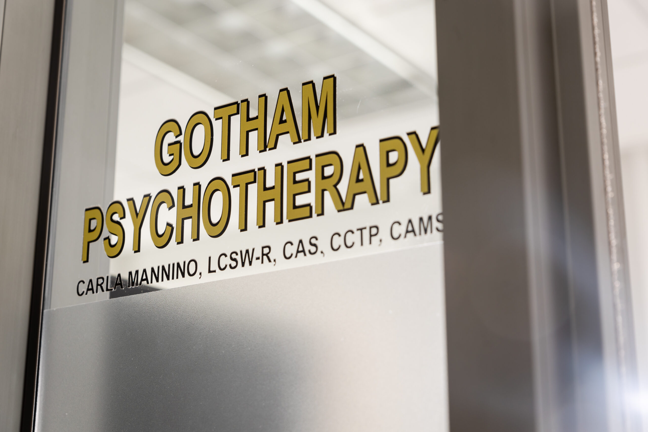 A window with the words gotham psychotherapy on it.