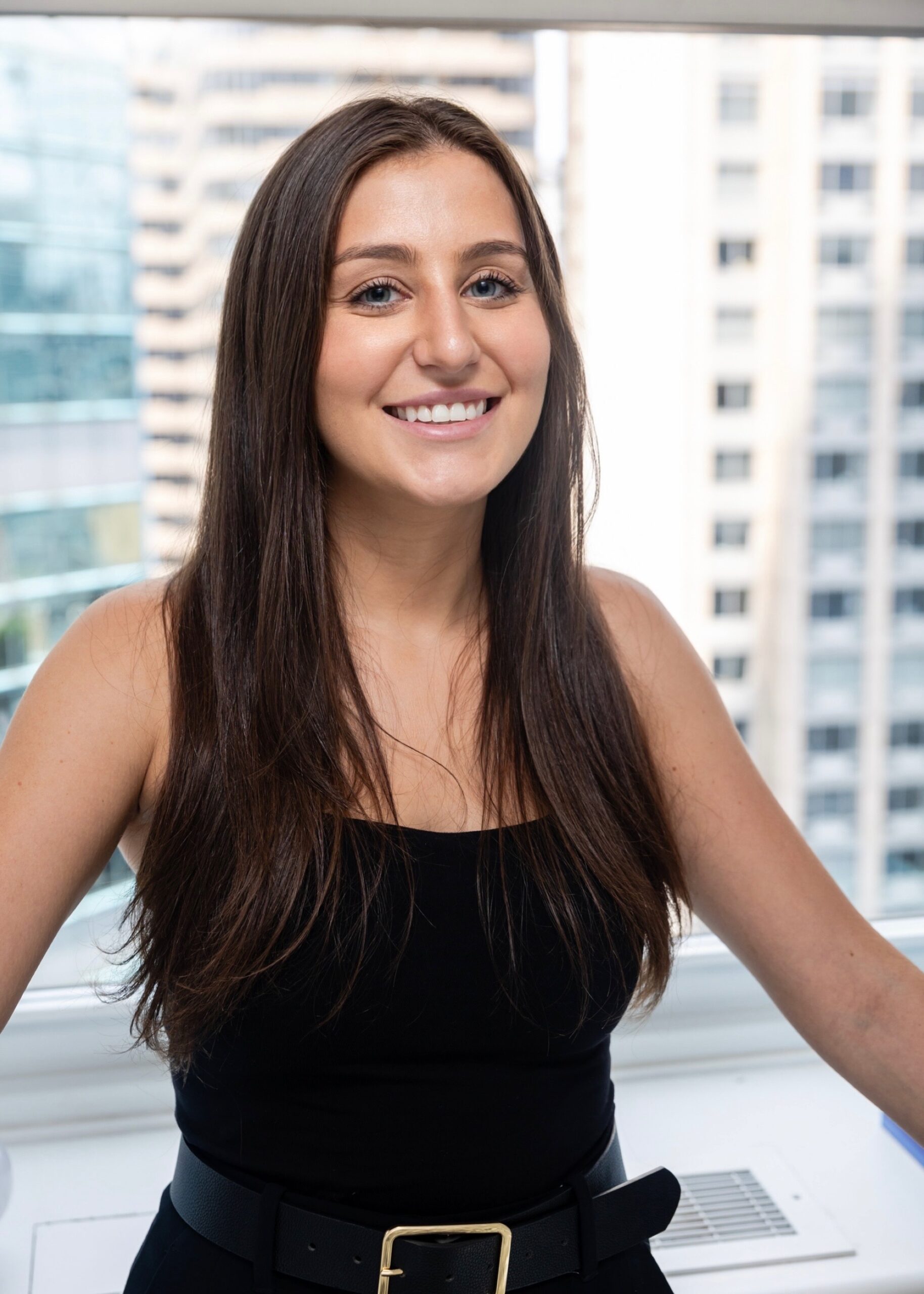 A woman in black shirt smiling for the camera.