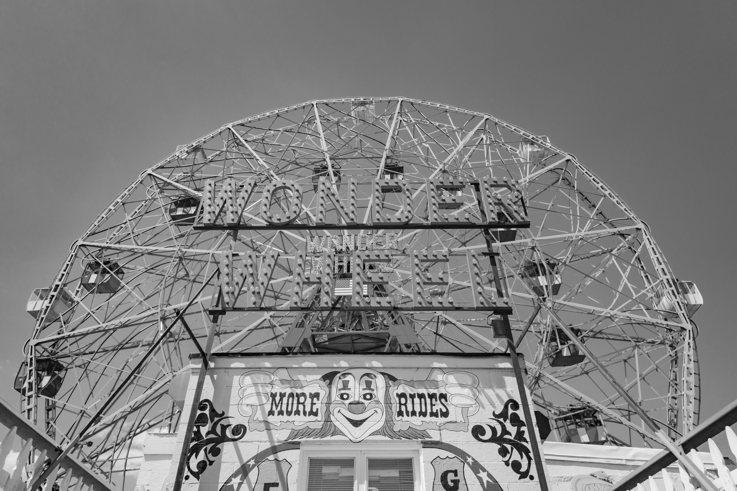 New York City, Coney Island, United States. Frontal view of the historic Wonder Wheel in Coney Island, Brooklyn. Close up of colored ticket office and red sign above. June 30, 2016